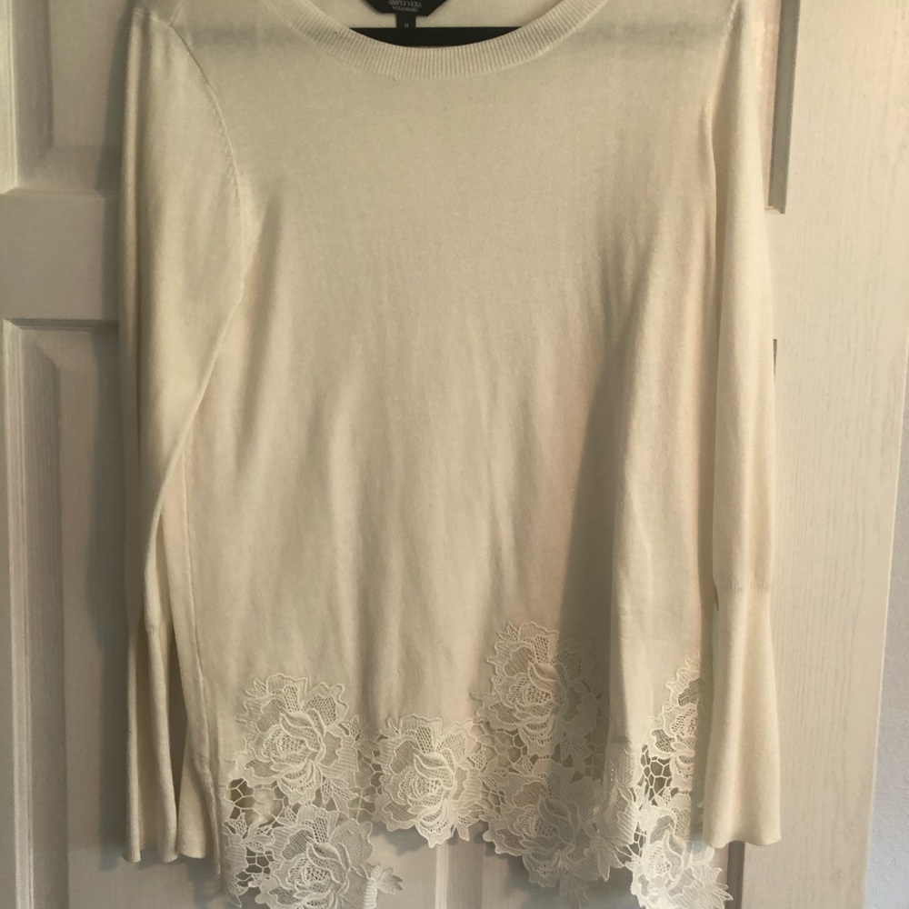 White sweater with lace trim.